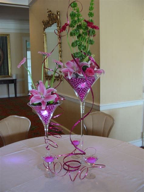 Centerpiece Using Martini Glasses Filled With Hot Pink Pearls Small Lights And Flowers Accented