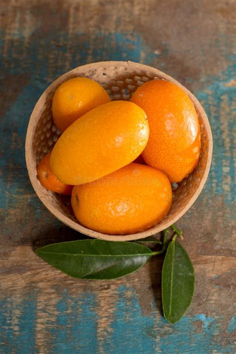 Delicious Small Citrus Fruits Kumquats Close Up On Wooden Table Stock