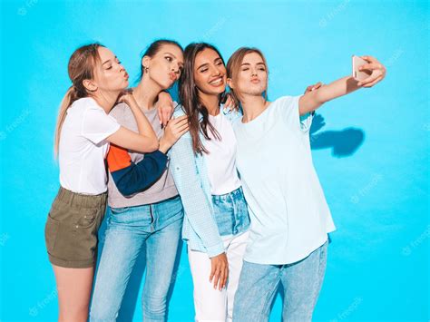 Free Photo Girls Taking Selfie Self Portrait Photos On Smartphonemodels Posing Near Blue Wall