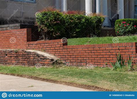 Old Brick Retaining Wall In Front Of Newer Red Brick
