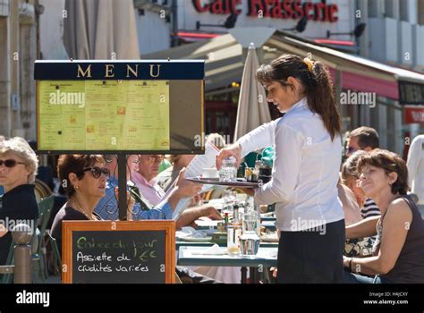 Waitress Serving Customers In Outdoor Cafe In Beaune Centre Burgundy
