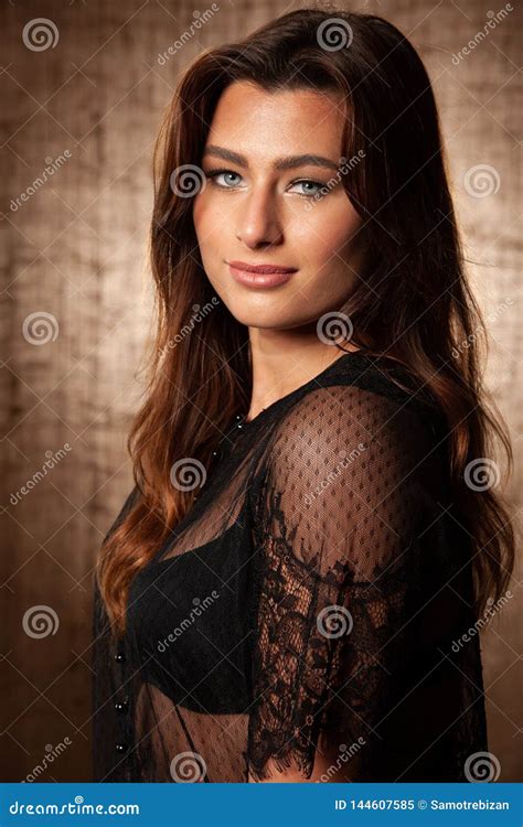 Bbeauty Portrait Of Cute Brunette Woman With Blue Eyes Over Grunge Brown Background Stock Image