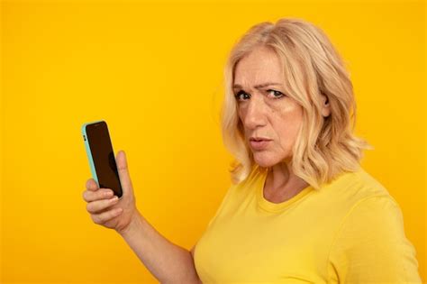 premium photo stunned frustrated woman holding phone isolated bad mobile concept