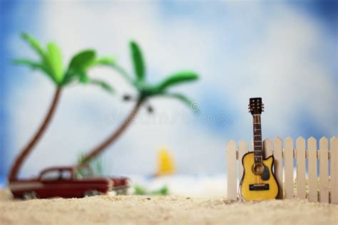 Guitar On Tropical Beach With Vintage Hot Rod In Background Stock Photo