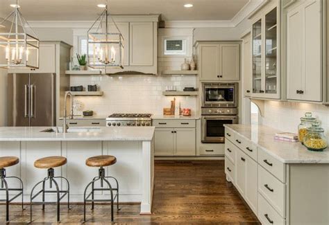 I absolutely loved designing the kitchen we see above. Greige Kitchen Cabinets Industrial farmhouse kitchen with ...