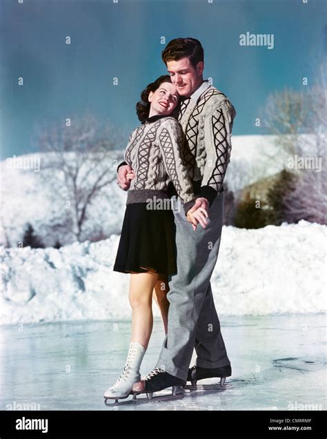 1940s 1950s Smiling Couple Ice Skating Wearing Matching Sweaters Stock