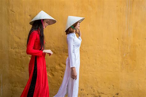 Vietnamese Women In Ao Dai Traditional Costume And Conical Hat By