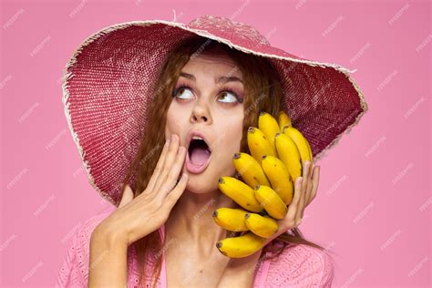 Premium Photo Woman With Bananas In Hands In Hat Exotic Fruits Lifestyle Pink Background
