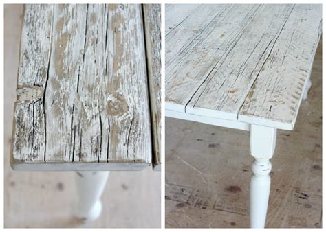 Rustic cottage dining room is fitted with a natural curiosities capistrano seaweed large 2 saudi blue framed art piece hung on white walls over a wood and metal bar table that faces a tall distressed wood dining table fitted with a riveted zinc top surrounded by swivel bar stools sat on a gray rug and finished with rush seats illuminated by an iron candelabra. Whitewashed Reclaimed Wood Dining Table - Satori Design ...