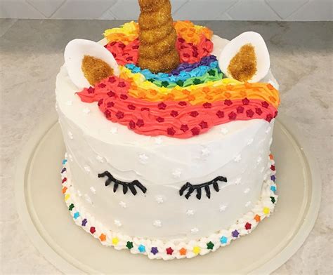 Unicorns grin among rainbows, hearts, stars and diamonds. Rainbow Layer Unicorn Cake - Remodelicious