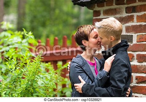 Two Lesbians Two Women Kissing Front Of Fence Horizon Format Canstock