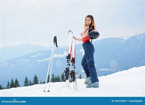 Woman Skier On The Top Of The Snowy Hill With Skis At Ski Resort Stock
