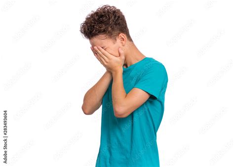 Foto Stock Portrait Of Teen Boy With Sad Expression Covering Face With
