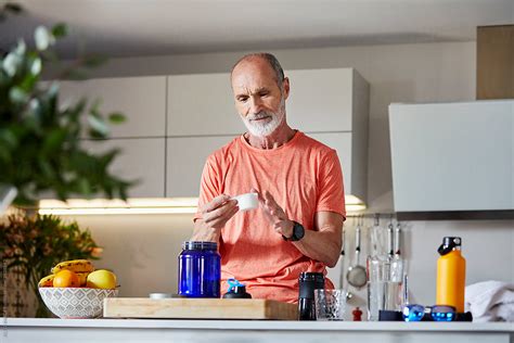 Active Senior Man Preparing Protein Drink Del Colaborador De Stocksy ALTO IMAGES Stocksy