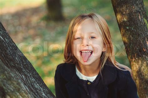 Pretty Schoolgirl Having Fun Outdoors Little Girl Shows Tongue Happy