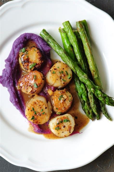 Perfectly Pan Seared Scallops Served With A Lemon Butter Sauce This