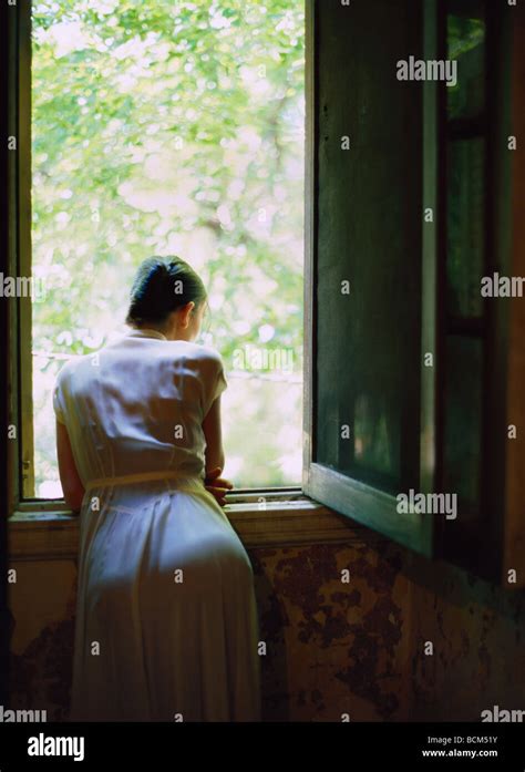 Woman Looking Out Window Rear View Stock Photo Alamy
