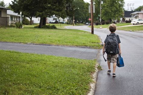 One Boy Walking To School With Backpack And Lunch Bag Stock Photo Offset