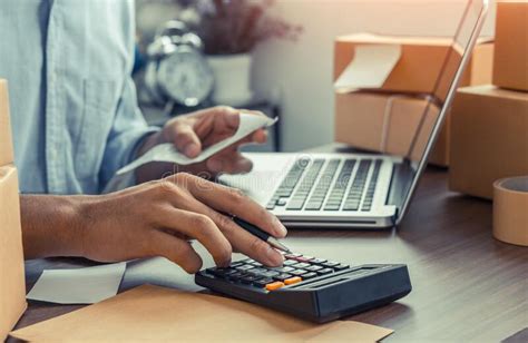 The Man Calculate Bills With Using Calculator In Home Office Stock
