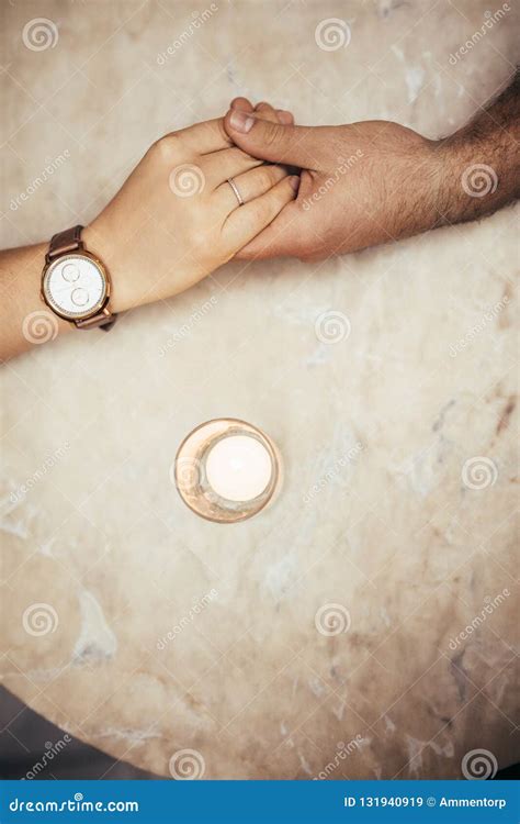 Close Up Of Hands Of A Romantic Couple On A Table Stock Image Image