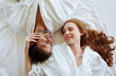 Romantic Couple Lying In Bed Of Hotel Room Stocksy United Upper Body