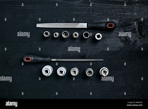 Set Of Tools Chisel Wrenches On Black Wooden Background Close Up Top
