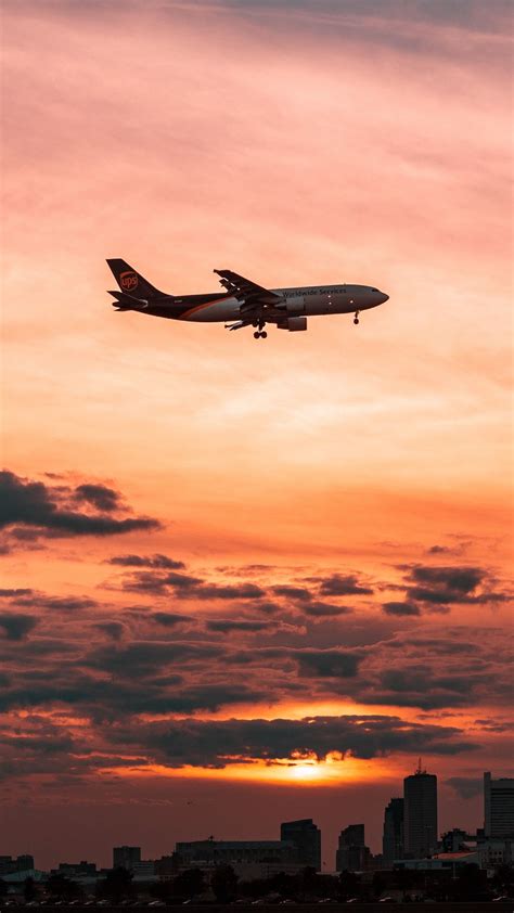 Download Wallpaper 1080x1920 Airplane Sky Flight Clouds Sunset