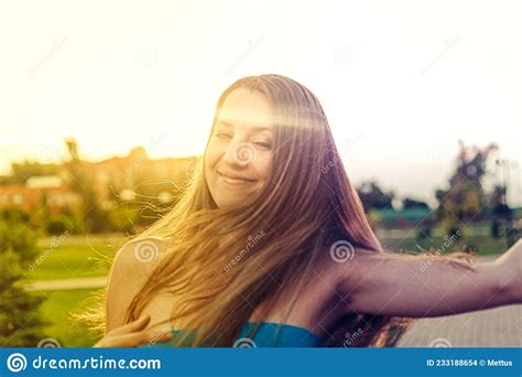 Nice Blond Haired Lady Closed Eyes Posing Outside In The Park Backlit By Summer Sun Stock Photo