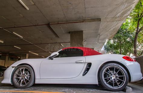 The Side Of Wheel Of White Porsche Sports Car Parked In The Parking Lot