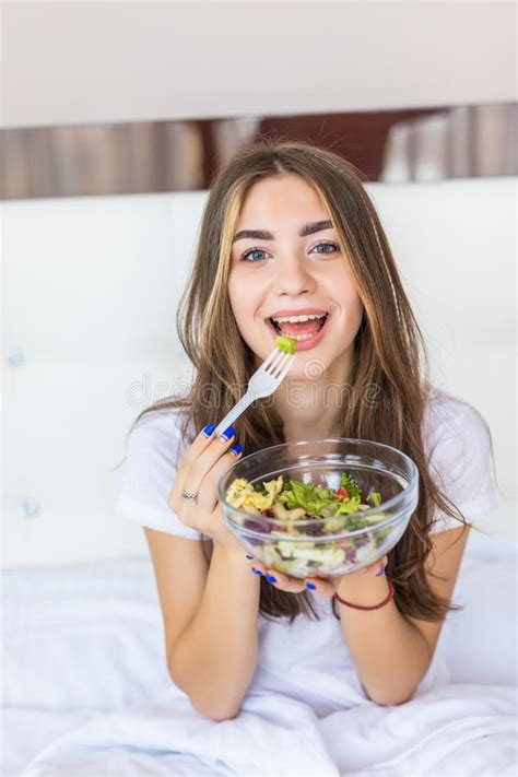 portrait of a happy smiling woman eating a healthy breakfast in bed stock image image of home