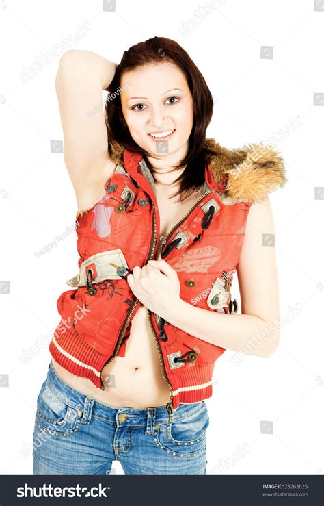 Standing Woman Holding Unziped Red Jacket With Hand And Other Hand Behind Head Stock Photo