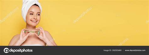 Smiling Beautiful Naked Woman Towel Head Jade Roller Isolated Yellow