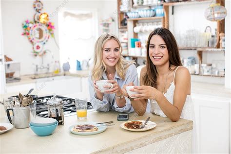 Young Women Eating Breakfast In Kitchen Stock Image F0207593
