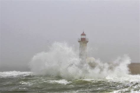 Lighthouse In Rough Seas With Crashing Waves Stock Photo Image Of