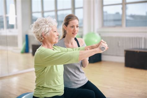 Senior Woman Training In The Gym With A Personal Trainer Minnesota