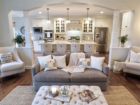 A sophisticated, neutral living room in chicago's historic palmolive building features a clever mix of antiques and vintage finds, which create a sense of balance. Open concept floorplan, open floorplan, living room ...