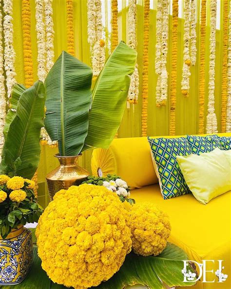A Yellow Couch With Flowers And Plants On It