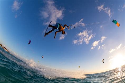 Free Photo Low Angle Shot Of A Person Surfing And Flying A Parachute