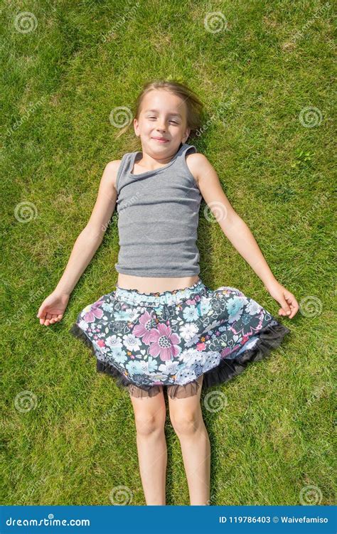 Child Girl Laying In Grass Under Summer Sun Stock Image Image Of
