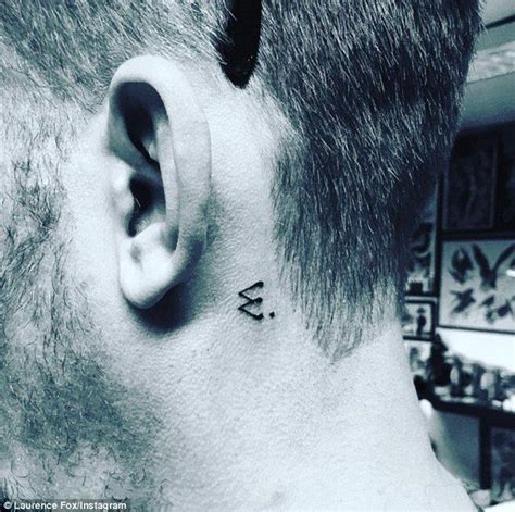 A Man With A Small Tattoo On His Ear