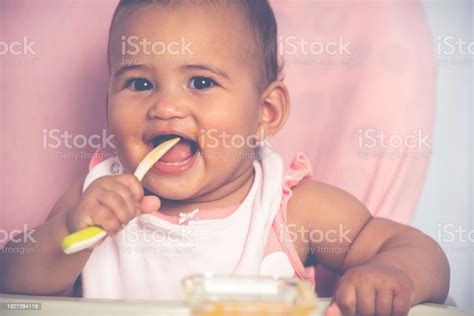 Adorable Baby Eating Food By Himself Stock Photo Download Image Now