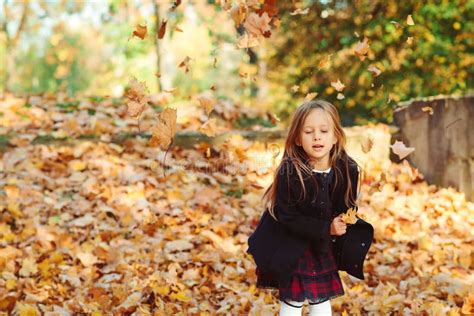 Adorable Schoolgirl Walking In Autumn Park After School Beautiful