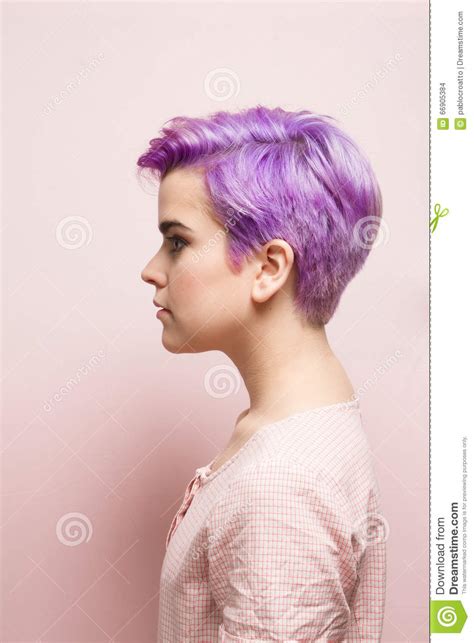 Left Profile Of A Violet Short Haired Woman In Pink Pastel Stock Photo