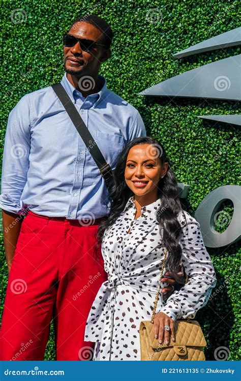 american professional basketball player chris bosh with his wife adrienne williams on the blue