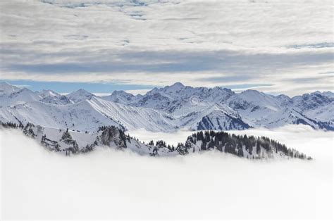 Snow Covered Mountains With Inversion Valley Fog And Trees Shrouded In
