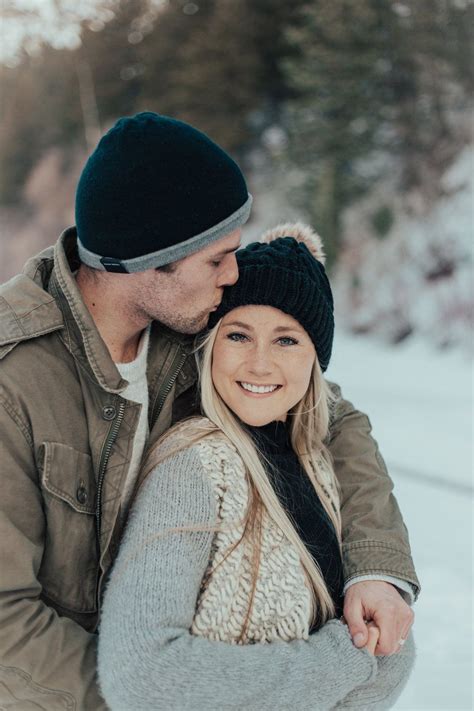 Snowy Winter Engagement Pictures In The Mountains Pine Trees Beanies