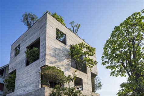 Trees Pop Out Of The Facade Of A Pentagonal Concrete House Designed By