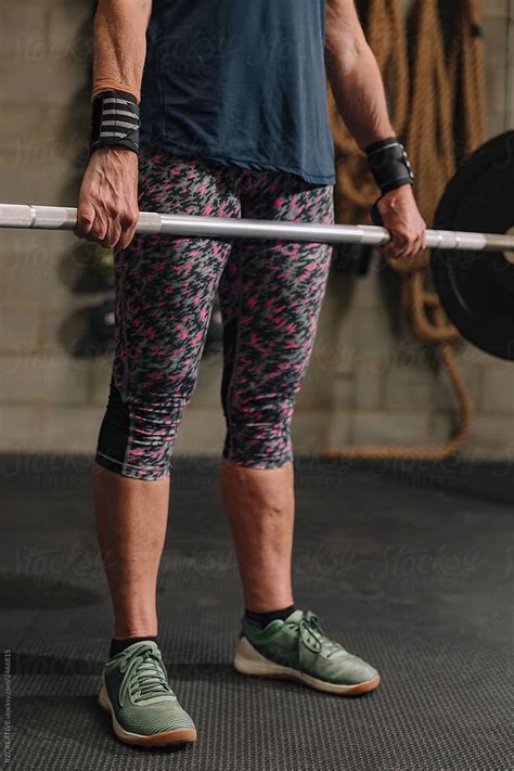 Senior Woman Lifting At Gym By Stocksy Contributor RZCREATIVE Stocksy