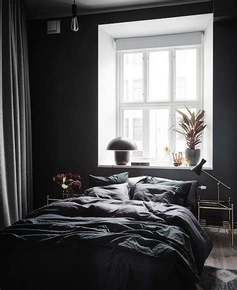 A Contemporary Bedroom With Black Walls Some Bulbs And Lamps And A