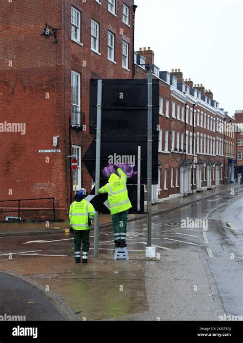 Worcester City Council Workers Removing Graffiti From A Road Sign In